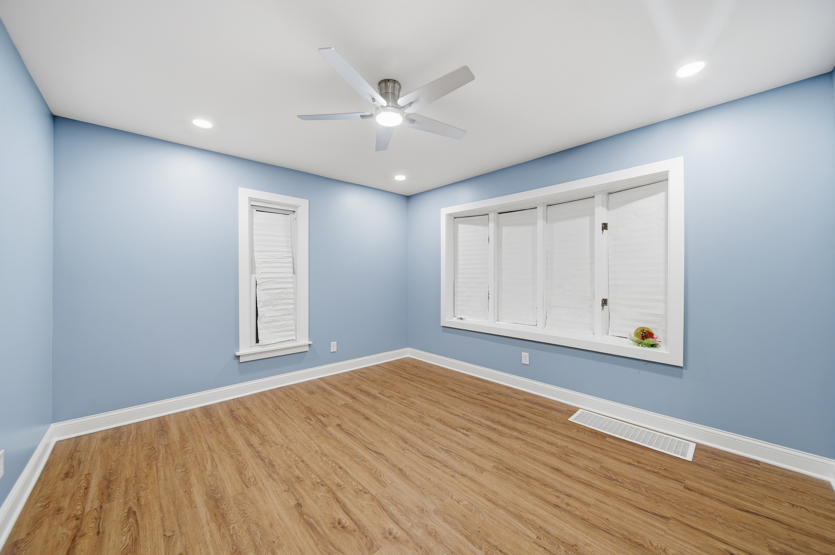 105 East Knox Street Morrison, IL 61270 - Photo 4 of 27 a view of an empty room with wooden floor and a window