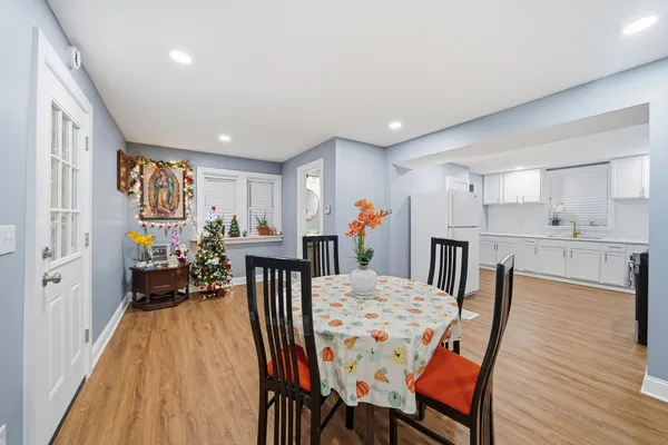 a view of a dining room with furniture and wooden floor