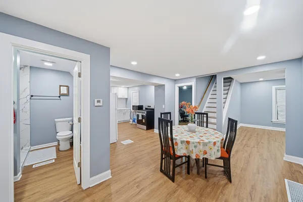 a view of a dining room with furniture and wooden floor