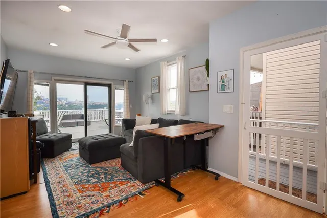 a living room with hard wood floor furniture and a rug