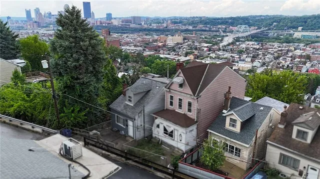 an aerial view of multiple houses with a yard