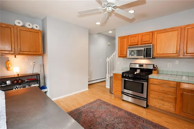 a kitchen with stainless steel appliances granite countertop a stove a sink and a refrigerator