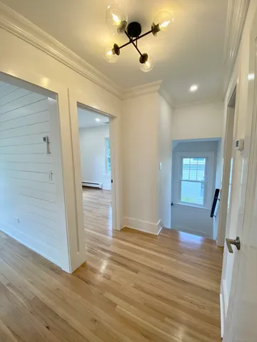 wooden floor in an empty room with a mirror