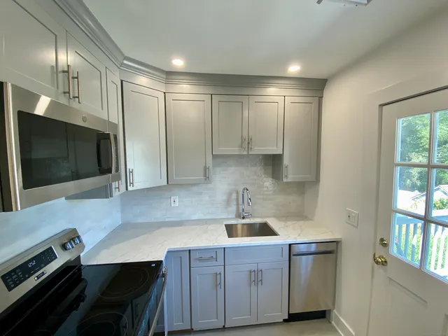 a kitchen that has a sink and a stove in it