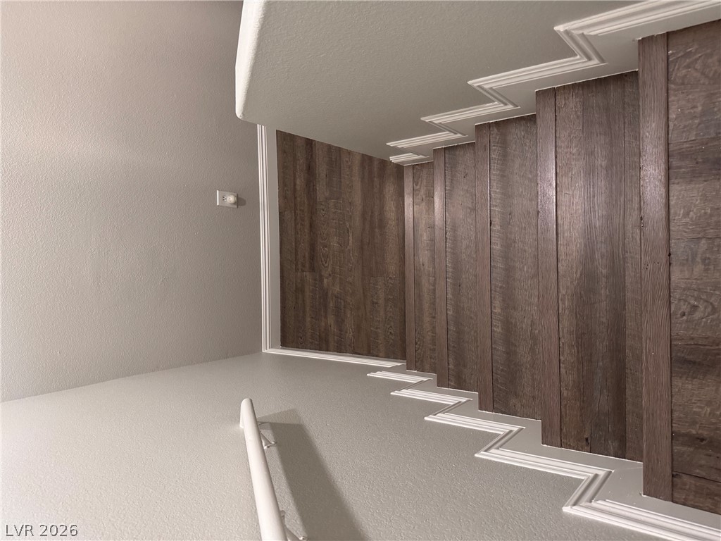 8937 Austin Ridge Avenue Las Vegas, NV 89178 - Photo 13 of 22 Rich wood-tone stairs ascend with elegant white trim, blending style and function.