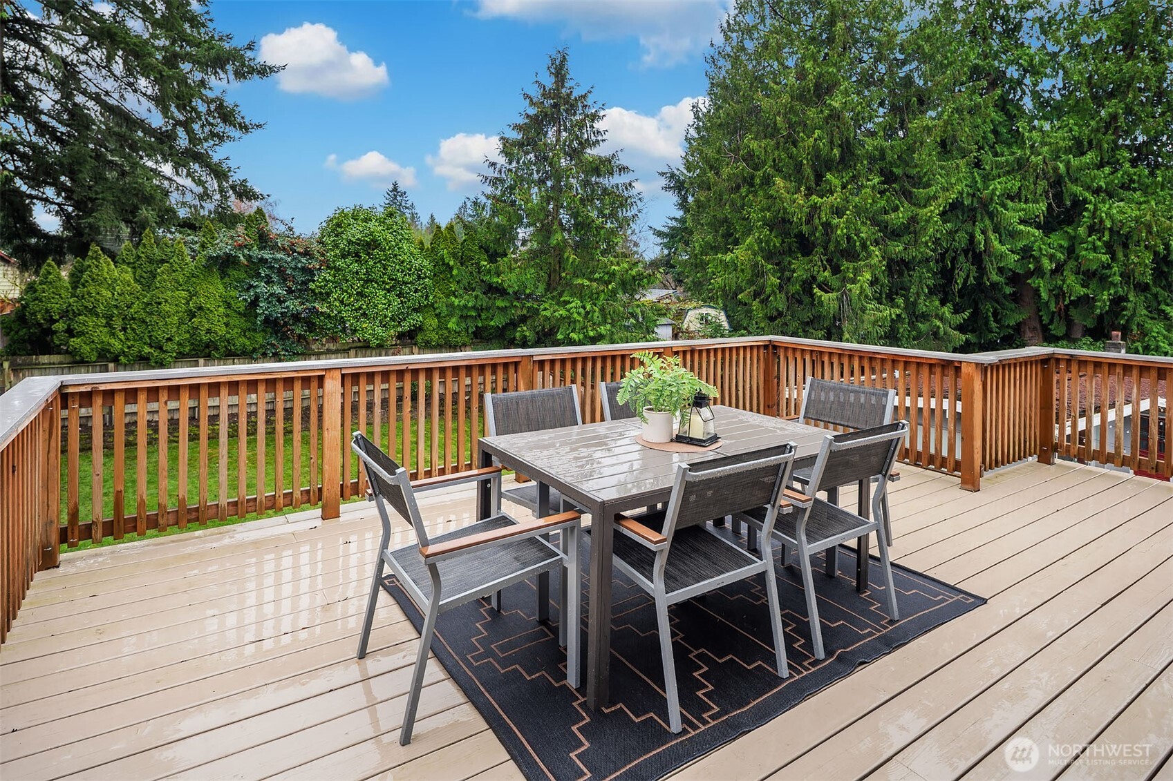 10017 Northeast 202nd Street Bothell, WA 98011 - Photo 12 of 38 a view of a roof deck with table and chairs and wooden floor