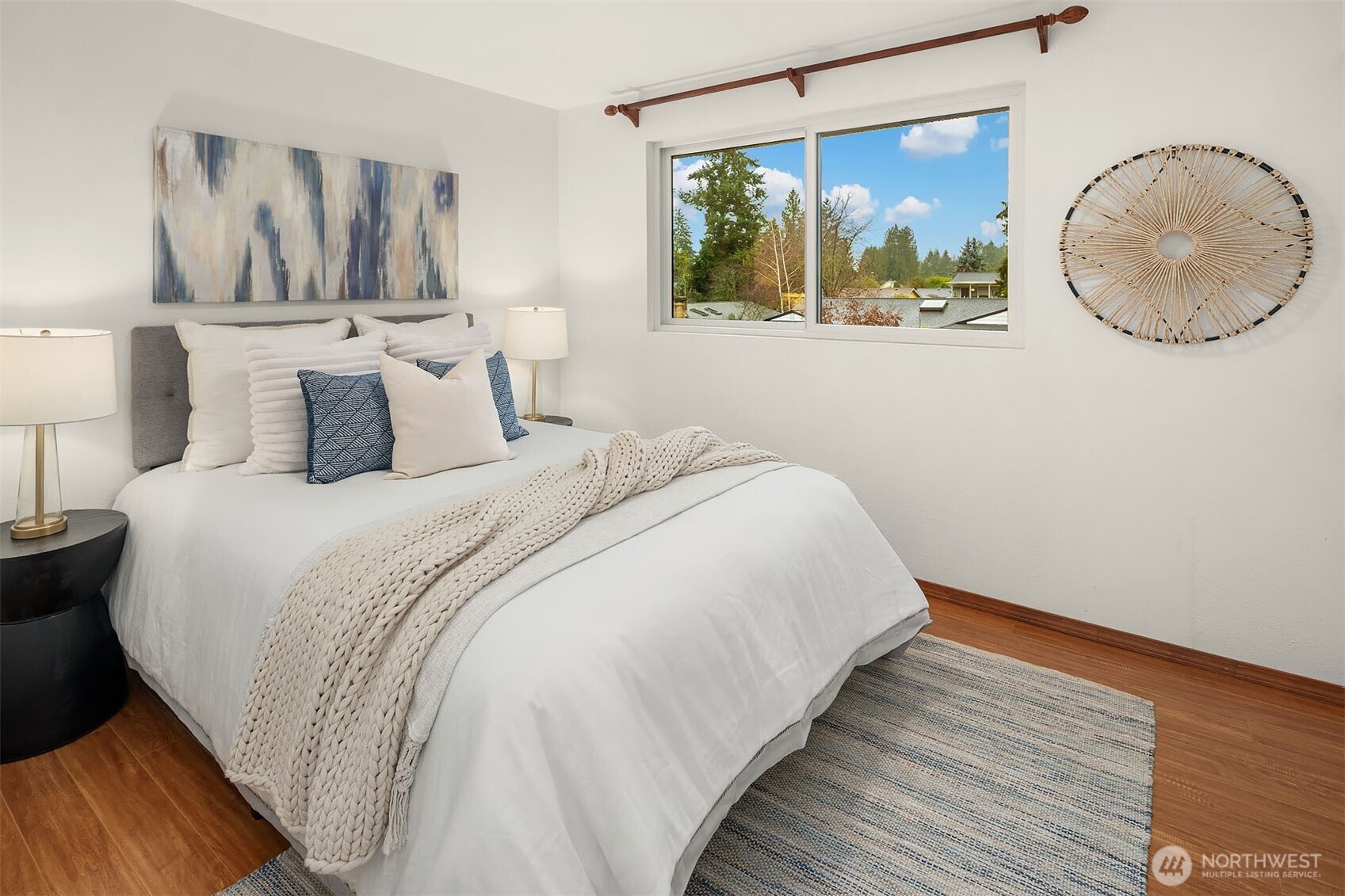 10017 Northeast 202nd Street Bothell, WA 98011 - Photo 18 of 38 a bedroom with bed and a painting on the wall
