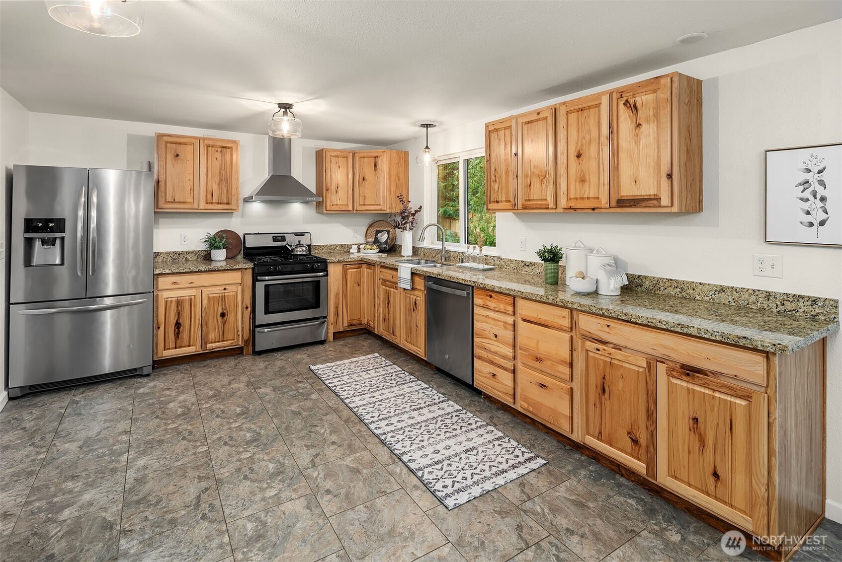 10017 Northeast 202nd Street Bothell, WA 98011 - Photo 8 of 38 a kitchen with stainless steel appliances granite countertop a stove top oven a sink dishwasher and a refrigerator