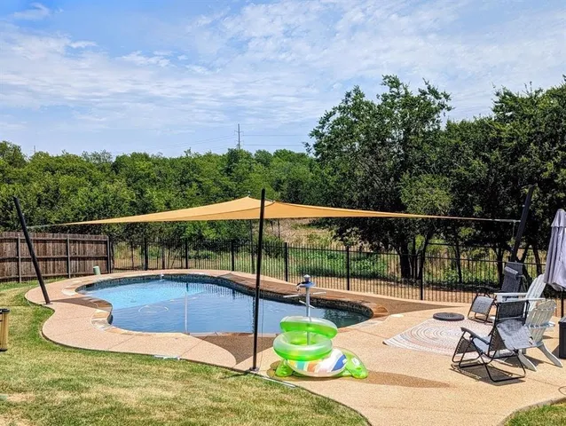 a view of a swimming pool with a patio