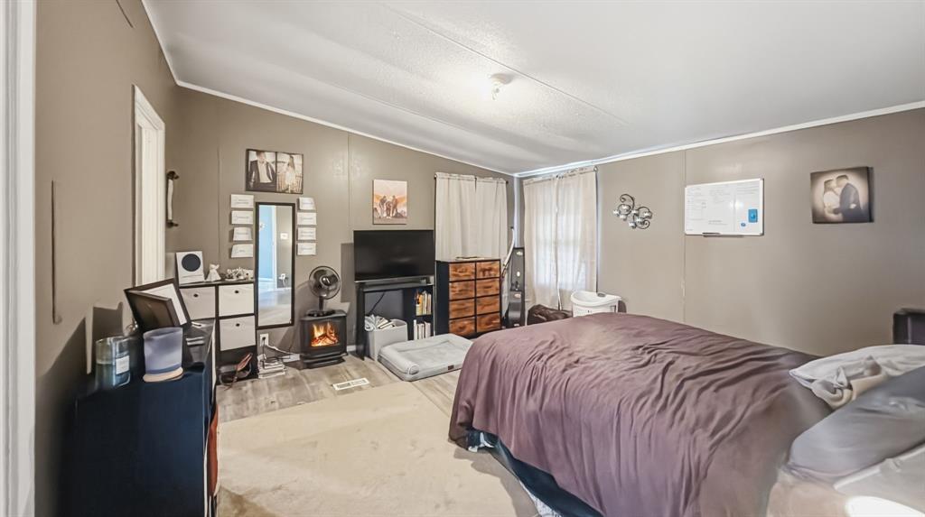 185 Private Road 4437 Rhome, TX 76078 - Photo 7 of 28 Spacious interior room featuring a vaulted ceiling and two windows
