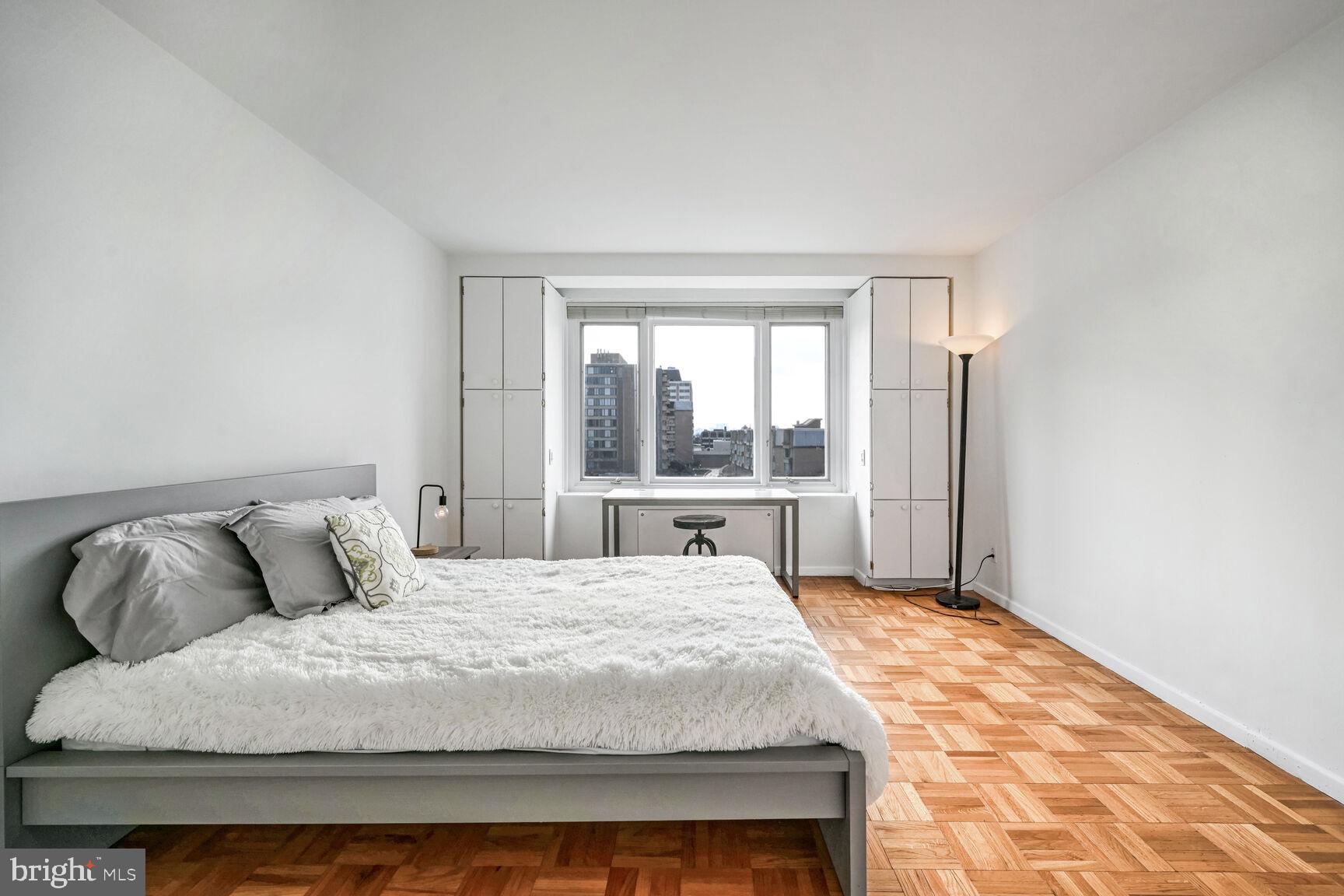 2475 Virginia Avenue Northwest, Unit 814 Washington, DC 20037 - Photo 11 of 29 a bedroom with a large bed and a large window