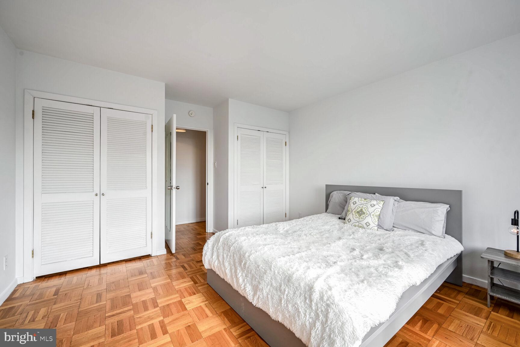 2475 Virginia Avenue Northwest, Unit 814 Washington, DC 20037 - Photo 12 of 29 a bedroom with a bed and a lamp