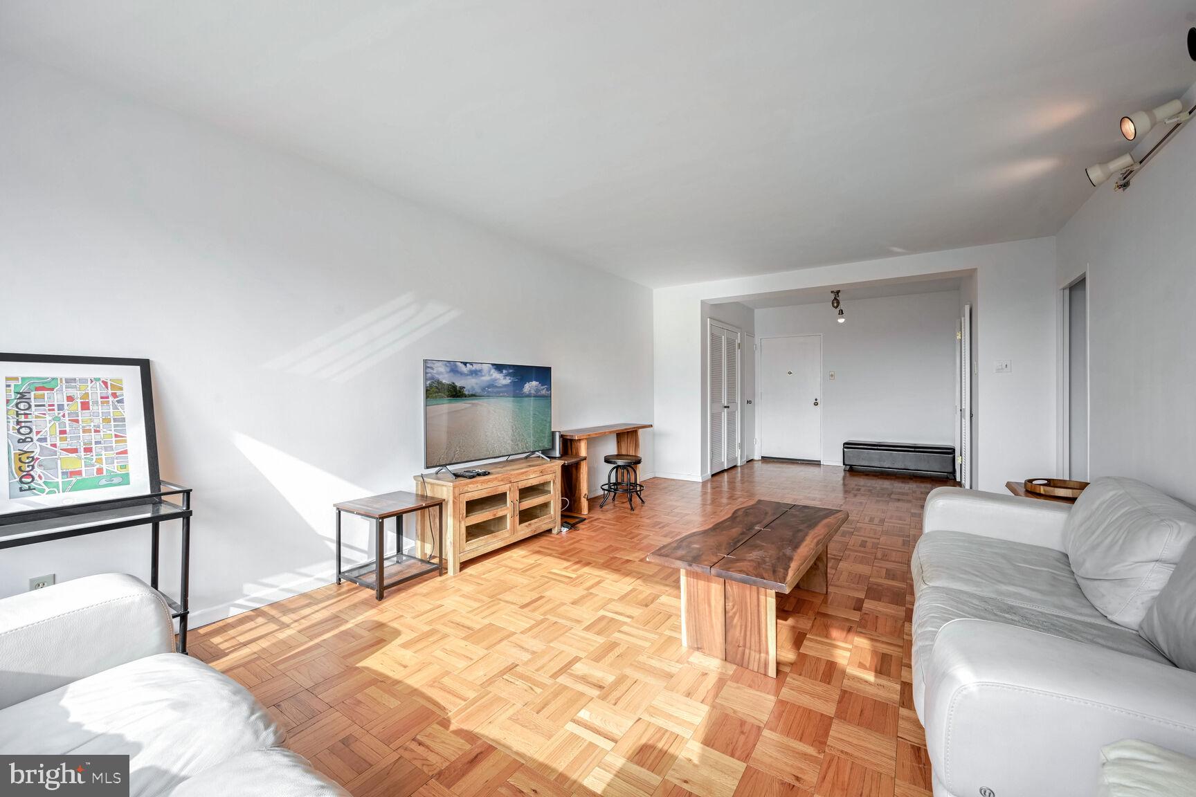 2475 Virginia Avenue Northwest, Unit 814 Washington, DC 20037 - Photo 4 of 29 a bedroom with furniture and a dresser