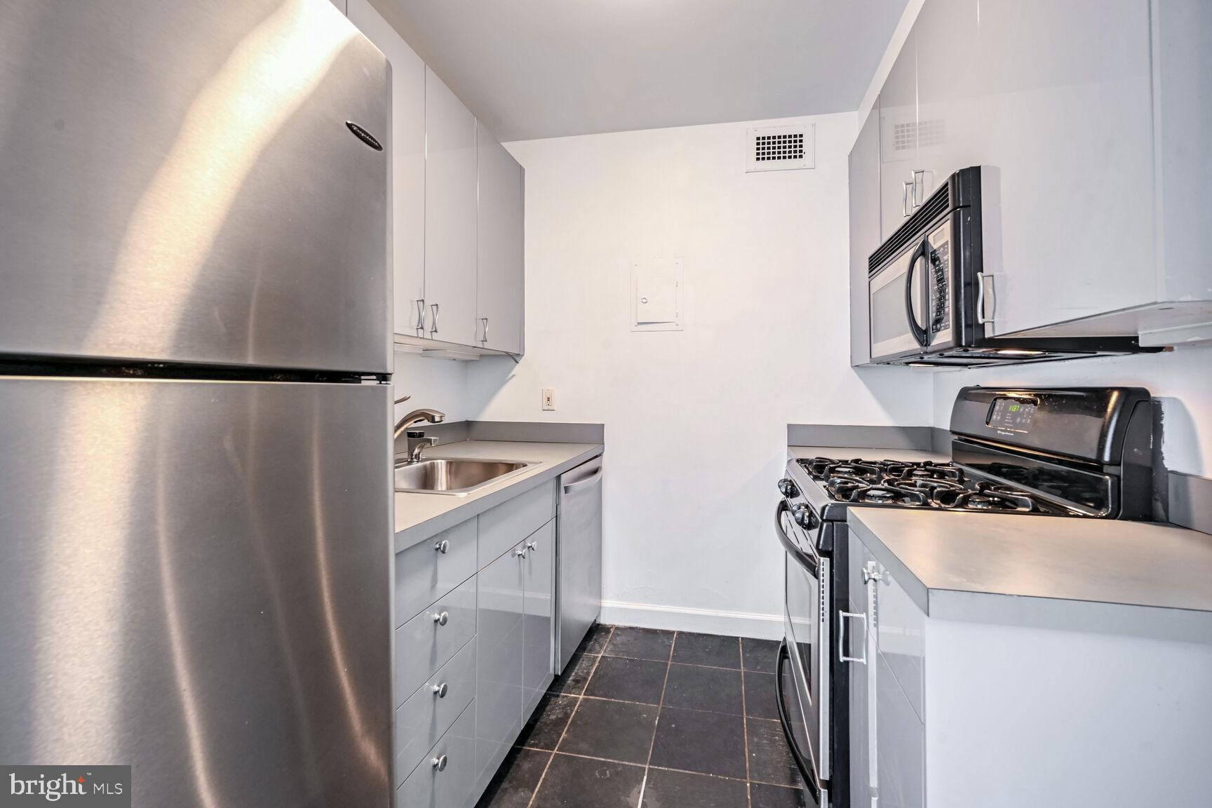 2475 Virginia Avenue Northwest, Unit 814 Washington, DC 20037 - Photo 6 of 29 a kitchen with a stove a refrigerator and a sink