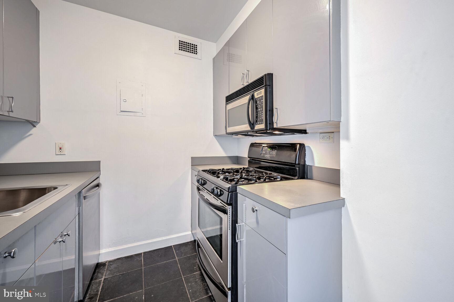 2475 Virginia Avenue Northwest, Unit 814 Washington, DC 20037 - Photo 7 of 29 a kitchen with a stove and a microwave