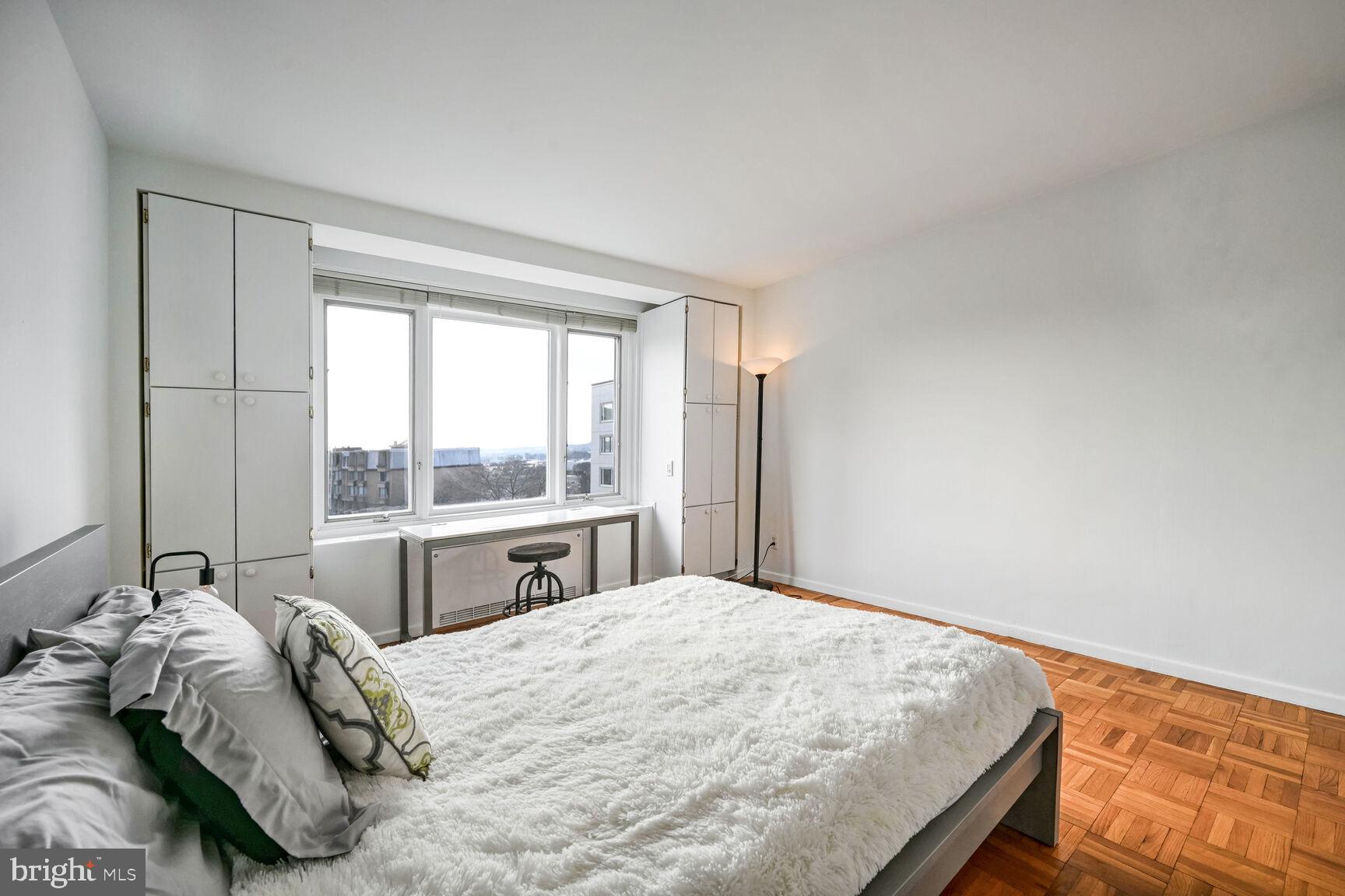 2475 Virginia Avenue Northwest, Unit 814 Washington, DC 20037 - Photo 10 of 29 a bedroom with a bed and a large window