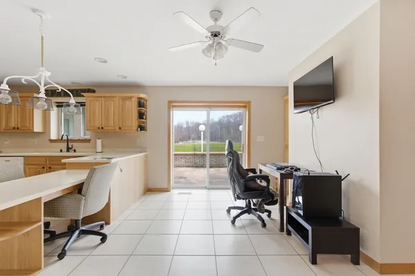 a room with a flat screen tv and chairs