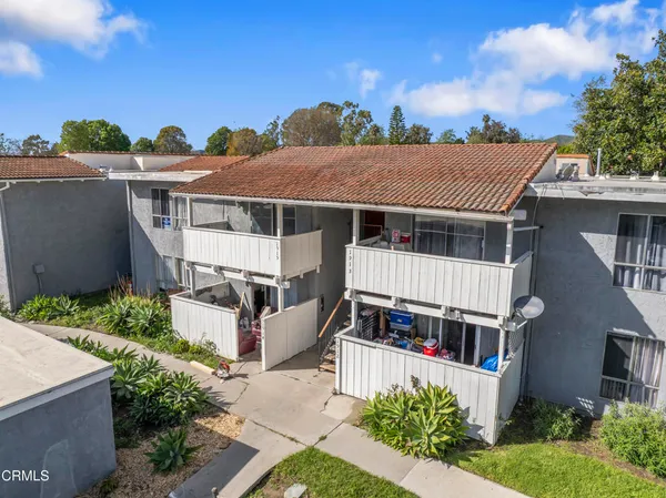 a aerial view of a house with a yard and potted plants