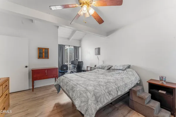 a spacious bedroom with a bed and a chandelier