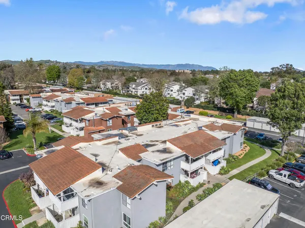 an aerial view of residential houses with outdoor space