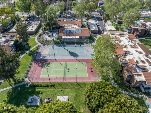 an aerial view of multiple houses with yard