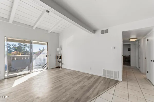 a view of a room with wooden floor and large window