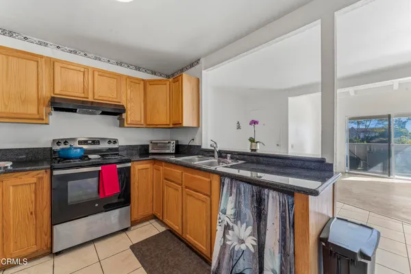a kitchen with stainless steel appliances granite countertop a sink stove and cabinets