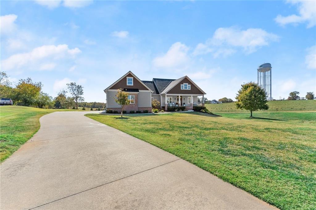 360 Clear View Court Clermont, GA 30527 - Photo 1 of 53 a view of a house with a big yard potted plants and large tree