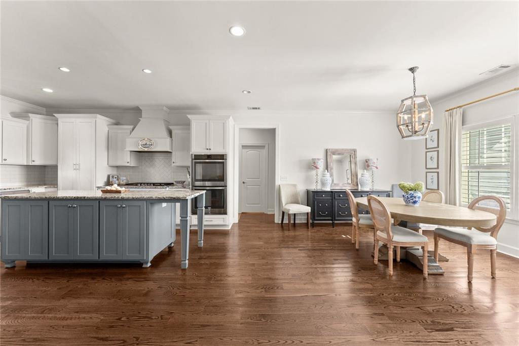 360 Clear View Court Clermont, GA 30527 - Photo 12 of 53 an open kitchen with wooden floor and stainless steel appliances