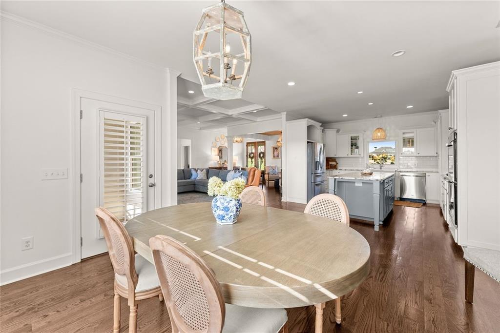 360 Clear View Court Clermont, GA 30527 - Photo 13 of 53 a dining room with furniture a kitchen and chandelier