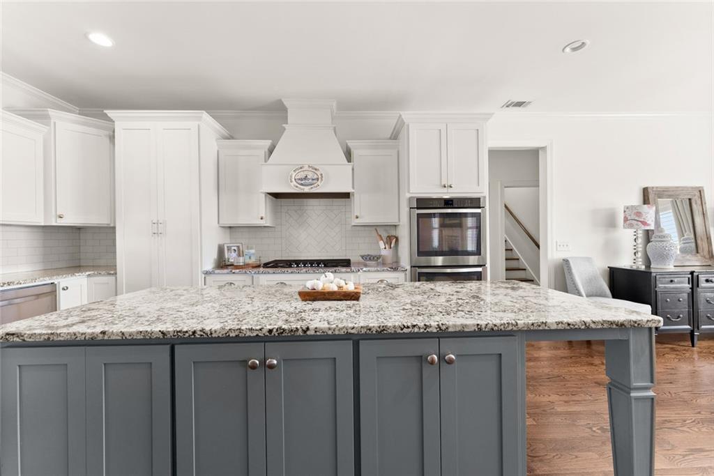 360 Clear View Court Clermont, GA 30527 - Photo 18 of 53 a kitchen with stainless steel appliances granite countertop a sink stove and refrigerator