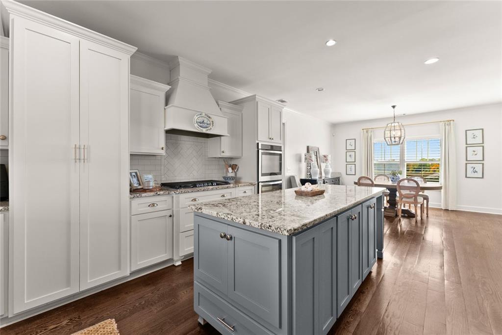 360 Clear View Court Clermont, GA 30527 - Photo 20 of 53 a kitchen with stainless steel appliances granite countertop a stove a sink dishwasher and a refrigerator with wooden floor
