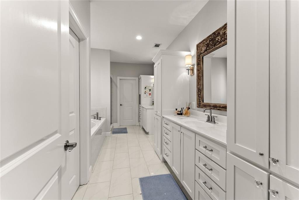 360 Clear View Court Clermont, GA 30527 - Photo 25 of 53 a spacious bathroom with a double vanity sink a mirror and a shower