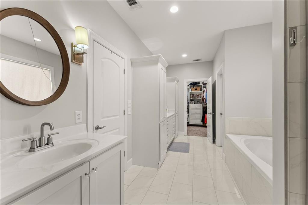 360 Clear View Court Clermont, GA 30527 - Photo 26 of 53 a en suite bathroom with a sink and a mirror