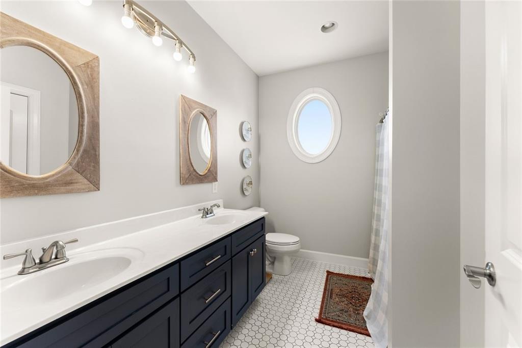 360 Clear View Court Clermont, GA 30527 - Photo 31 of 53 a bathroom with a double vanity sink mirror and toilet