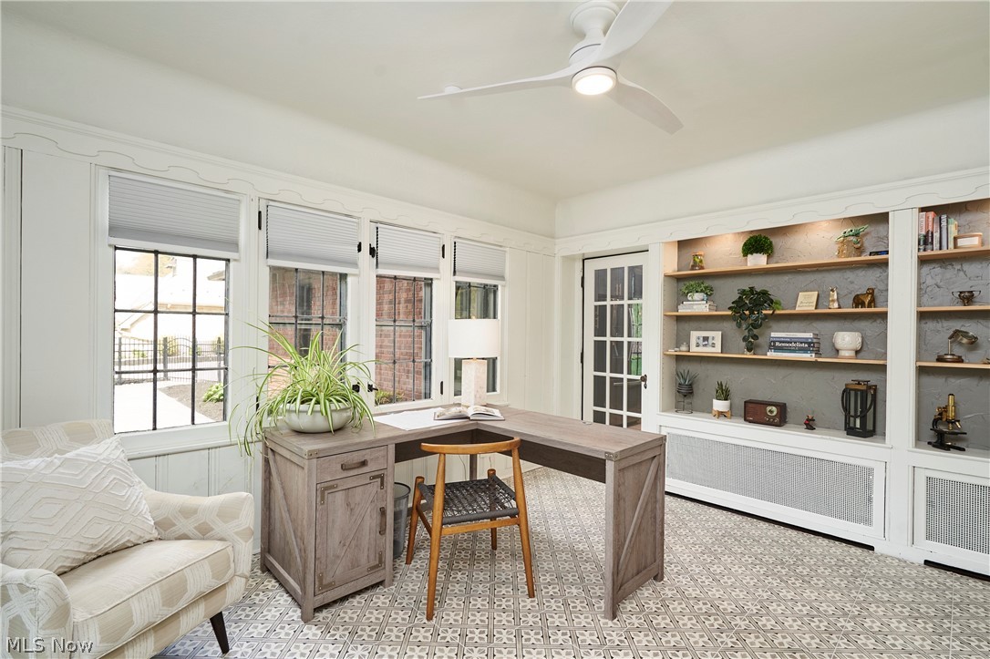 644 Ridgecrest Road Akron, OH 44303 - Photo 13 of 47 Dedicated room featuring built-in shelving with integrated lighting, a ceiling fan, patterned floor tiles, and multiple windows