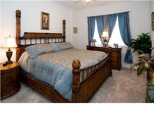 5 Calhoun Avenue, Unit 606 Destin, FL 32541 - Photo 14 of 18 a bed sitting in a bedroom next to a window
