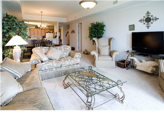 5 Calhoun Avenue, Unit 606 Destin, FL 32541 - Photo 5 of 18 a living room with furniture and a flat screen tv