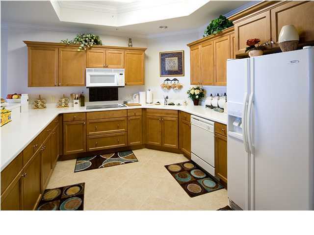 5 Calhoun Avenue, Unit 606 Destin, FL 32541 - Photo 7 of 18 a kitchen with a refrigerator and a sink