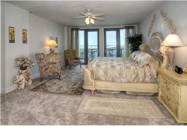 5 Calhoun Avenue, Unit 606 Destin, FL 32541 - Photo 8 of 18 a living room with a bed furniture chandelier and a large window