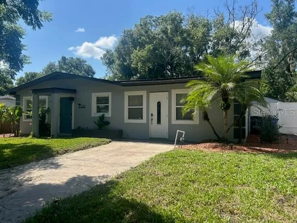 a house that has a tree in front of it