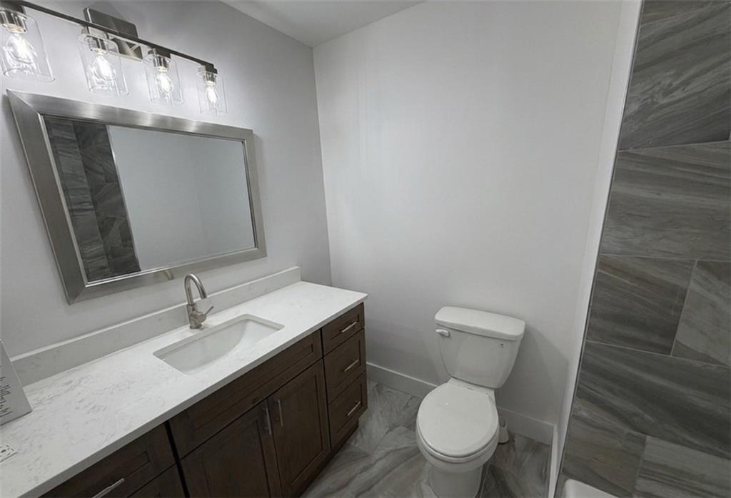 3763 Elkridge Drive Decatur, GA 30032 - Photo 10 of 20 a bathroom with a toilet a sink and mirror