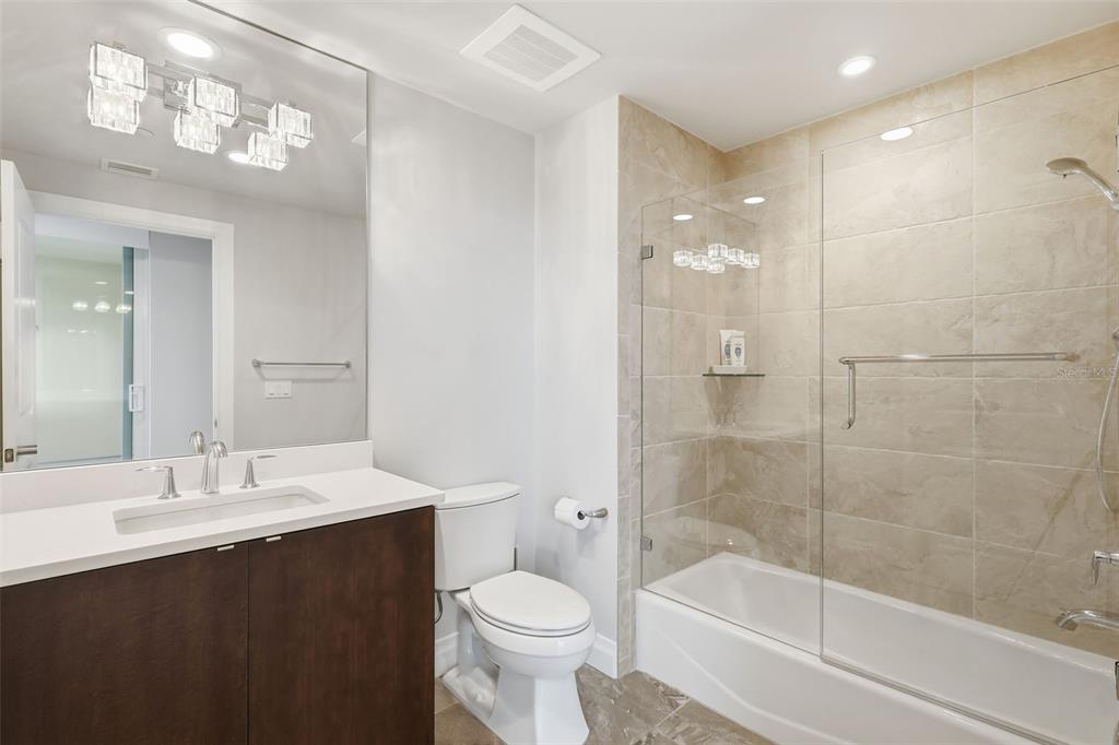 800 Collany Road, Unit 302 St. Petersburg, FL 33715 - Photo 35 of 66 a bathroom with a bathtub shower sink mirror and toilet