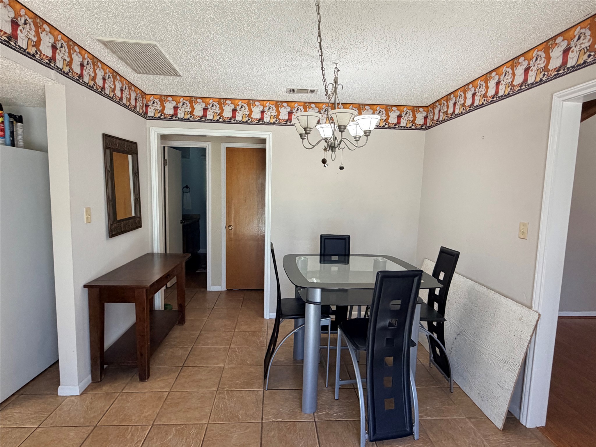 2800 Robin Road Manchaca, TX 78652 - Photo 10 of 28 Tiled flooring and a detailed wall border line this versatile dining space.