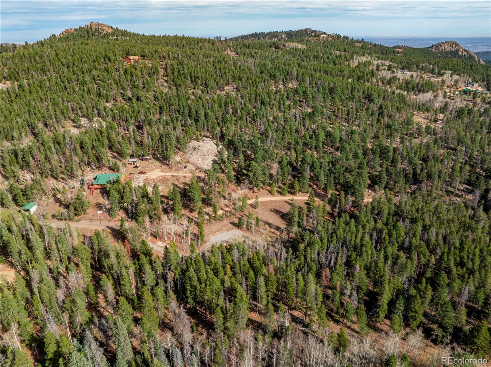 Lot 216620 Indian Springs Road Conifer, CO 80433 - Photo 27 of 37 a view of a lush green field with a mountain in the background