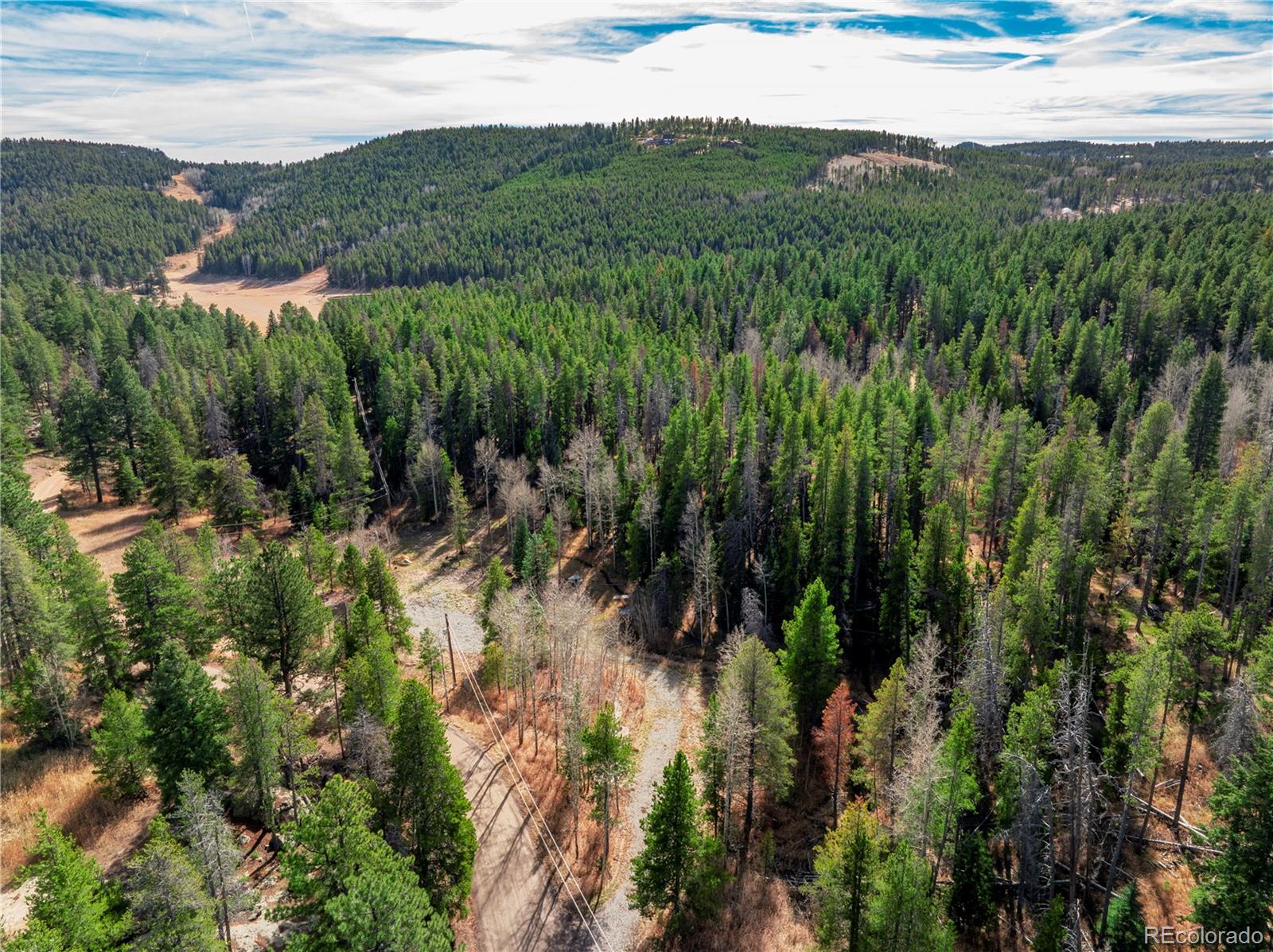 Lot 216620 Indian Springs Road Conifer, CO 80433 - Photo 10 of 42 a view of a lush green hillside and houses