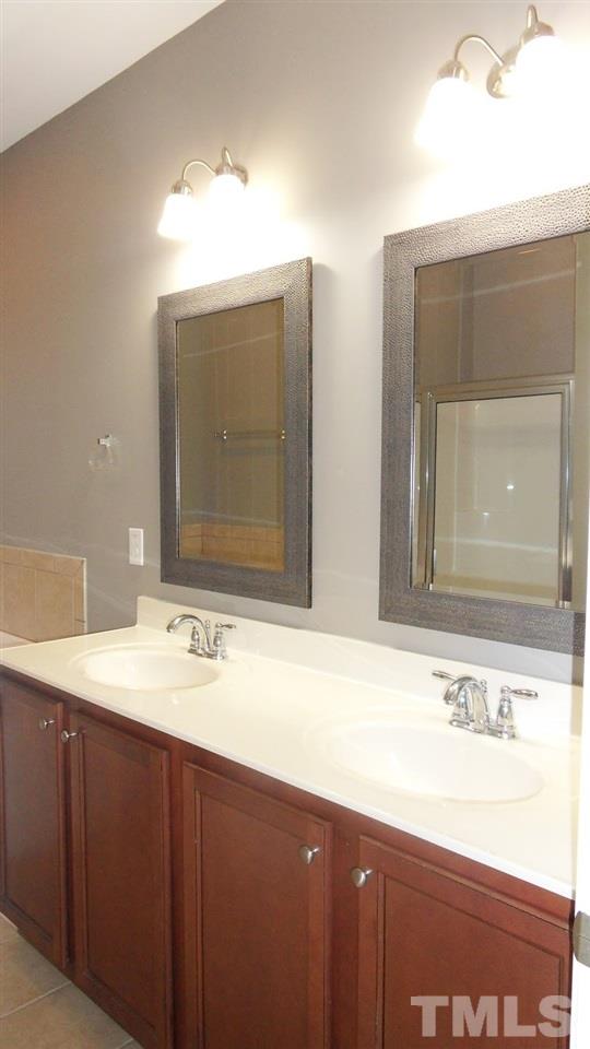 14324 Foxcroft Road Raleigh, NC 27614 - Photo 13 of 25 Large master bath with double vanity, framed mirrors, a stall shower and garden tub.