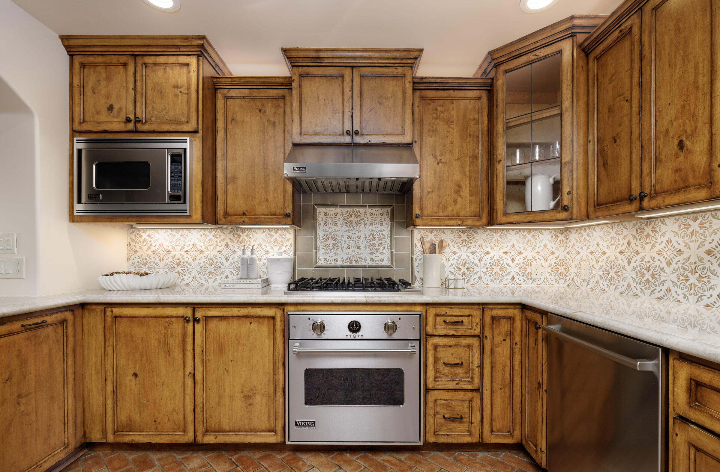 900 Las Alturas Road Santa Barbara, CA 93103 - Photo 17 of 42 a kitchen with granite countertop cabinets stainless steel appliances and wooden floor
