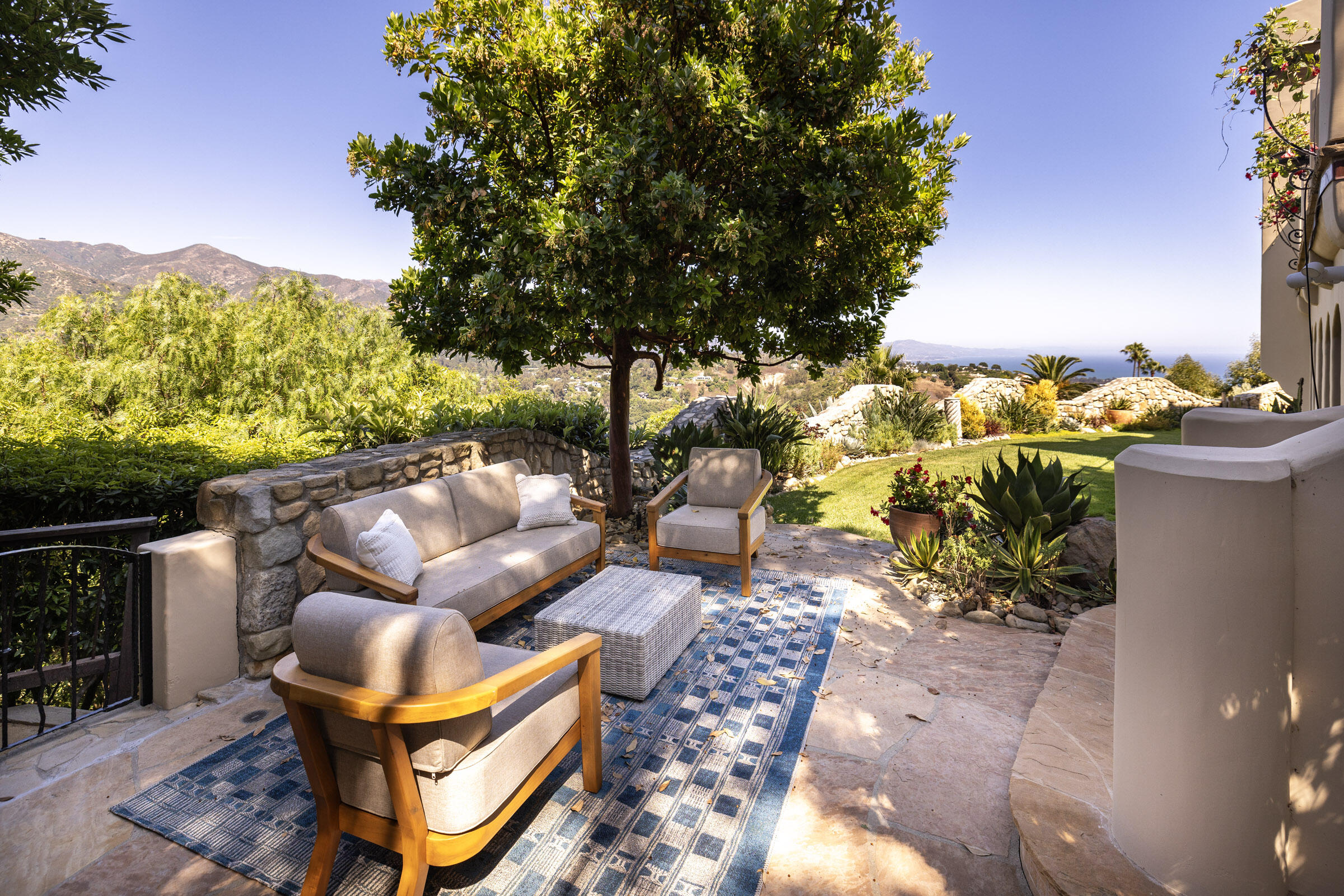 900 Las Alturas Road Santa Barbara, CA 93103 - Photo 34 of 42 a backyard of a house with table and chairs