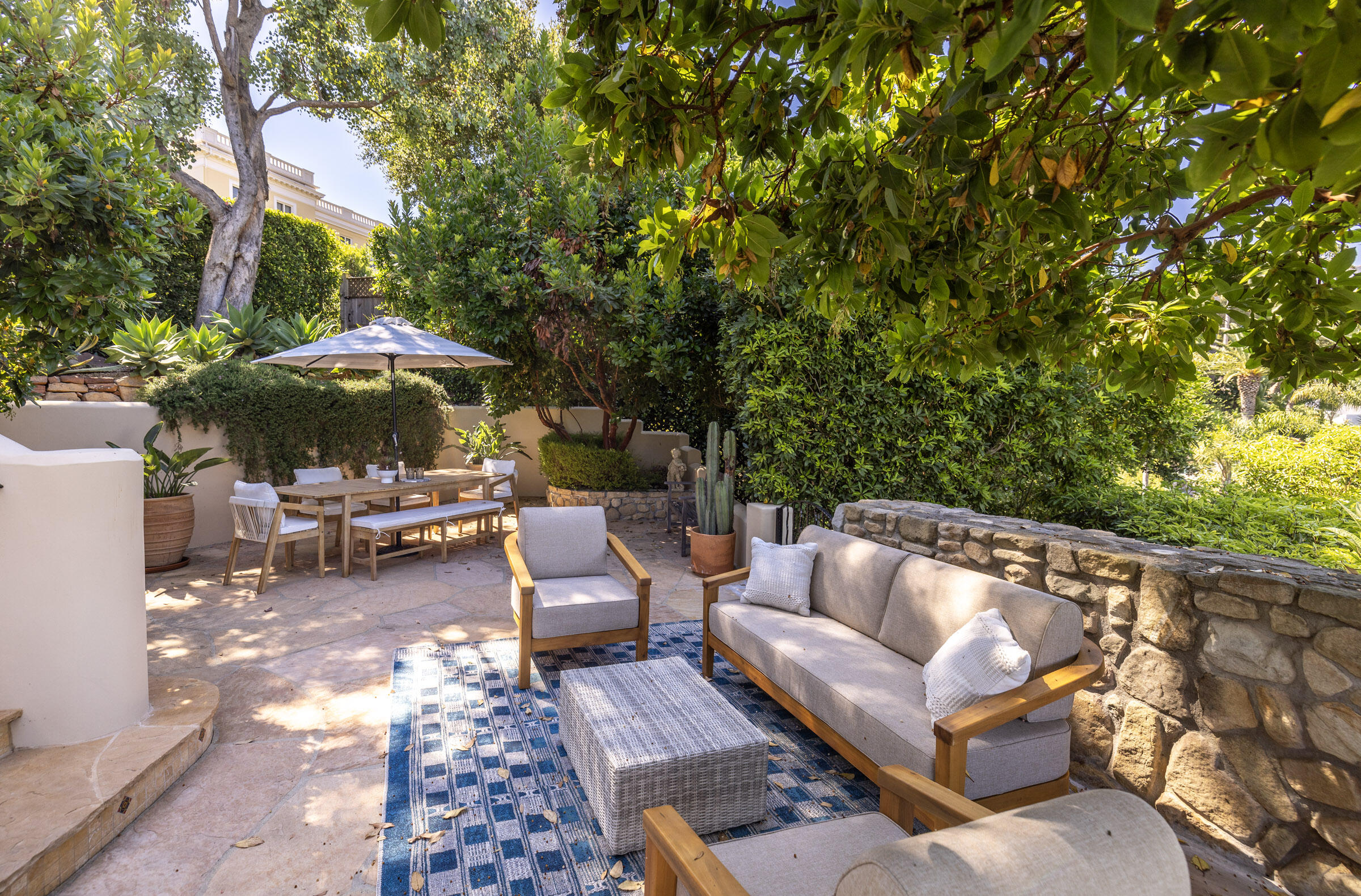 900 Las Alturas Road Santa Barbara, CA 93103 - Photo 35 of 42 a view of patio with chairs and a table under an umbrella